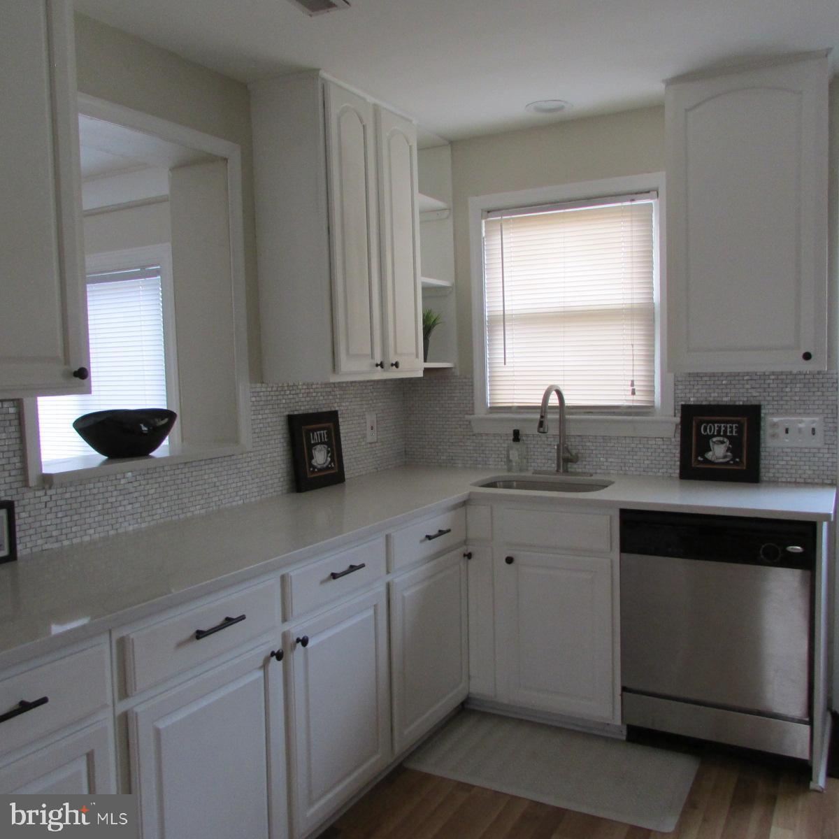 3605 Enterprise Road Bowie, MD 20721 - Photo 12 of 23 a kitchen with granite countertop white cabinets sink and window