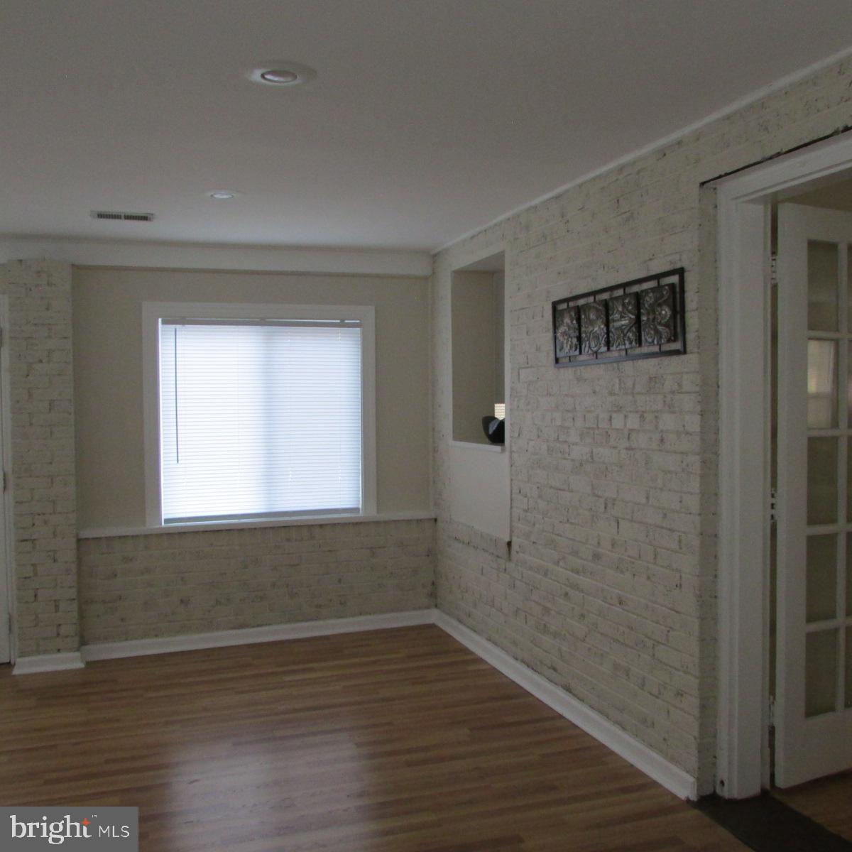 3605 Enterprise Road Bowie, MD 20721 - Photo 15 of 23 a view of an empty room with wooden floor and a window