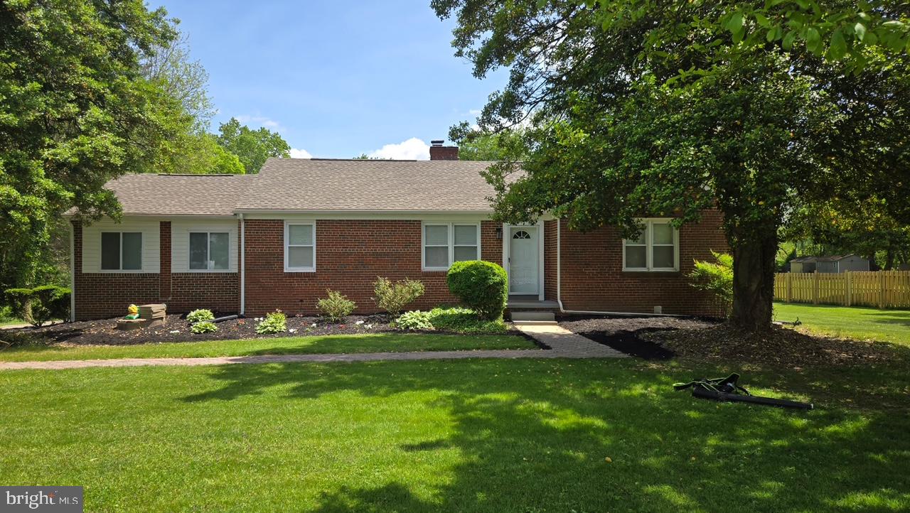 3605 Enterprise Road Bowie, MD 20721 - Photo 2 of 23 a front view of a house with a garden and yard