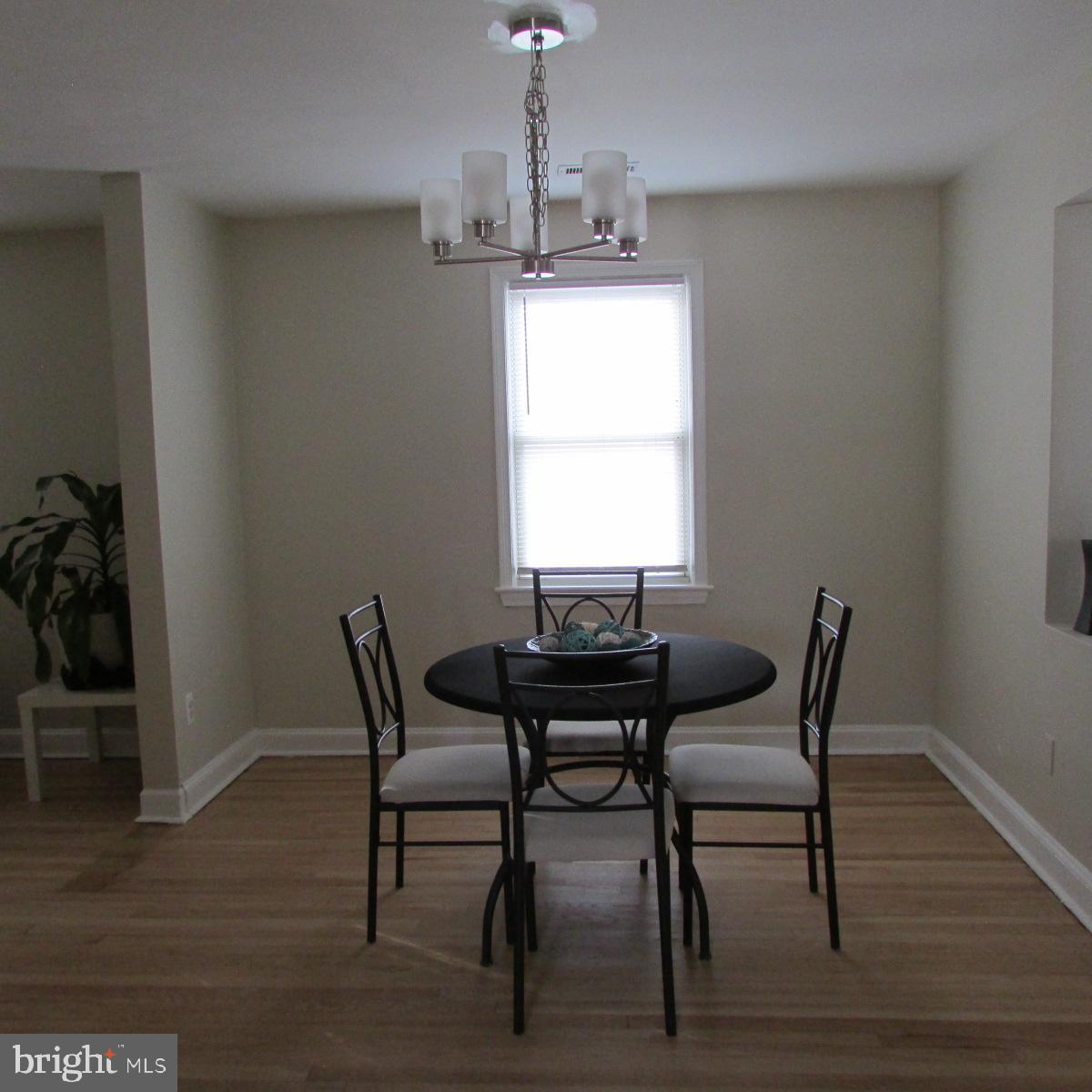 3605 Enterprise Road Bowie, MD 20721 - Photo 8 of 23 a dining room with furniture a chandelier and wooden floor