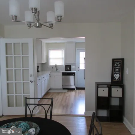 a kitchen with kitchen island white cabinets and stainless steel appliances