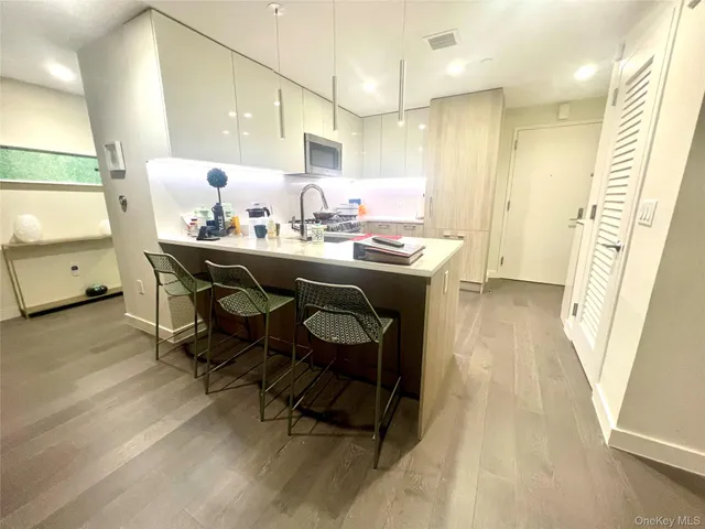 a kitchen with a sink cabinets and window