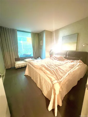 a bedroom with a bed and a night stand