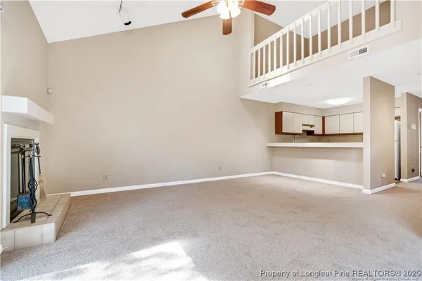 a view of an empty room with a fireplace