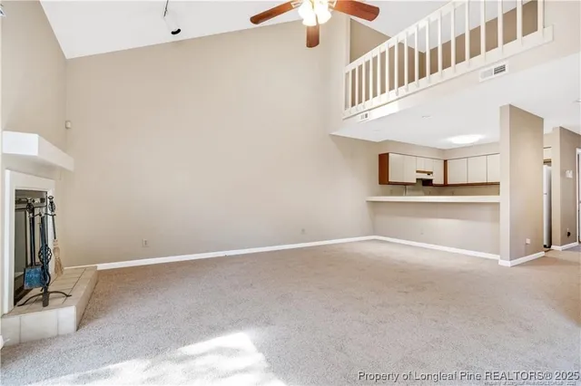 a view of an empty room with a fireplace