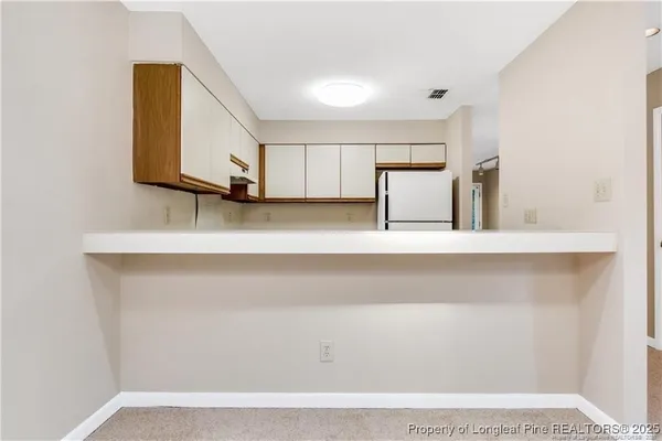 a view of a room with a cabinet and a potted plant