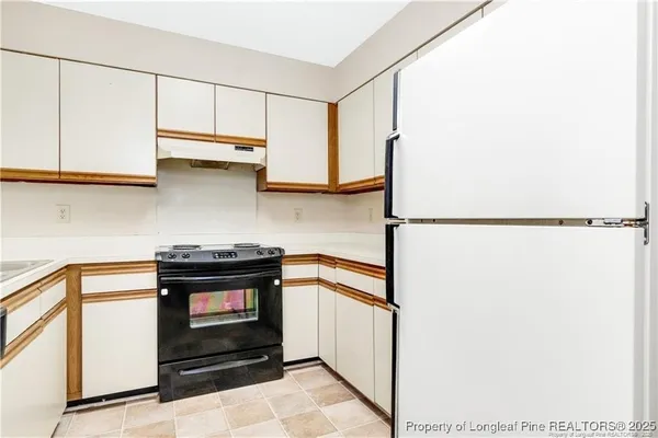 a kitchen with stainless steel appliances granite countertop a sink and a stove