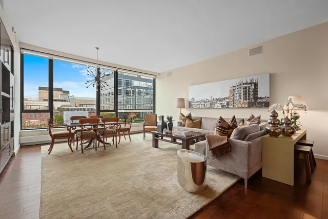 a living room with furniture and large windows