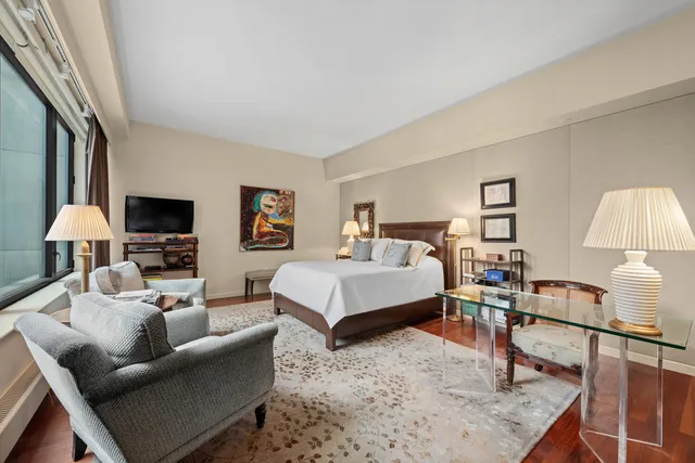 a bedroom with furniture and a lamp