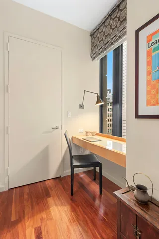 a view of a workspace with furniture and wooden floor