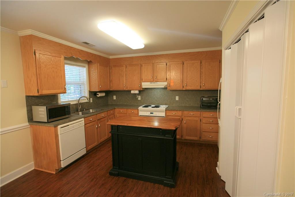 309 Old Williams Road Wingate, NC 28174 - Photo 8 of 15 a kitchen with stainless steel appliances granite countertop a sink and cabinets