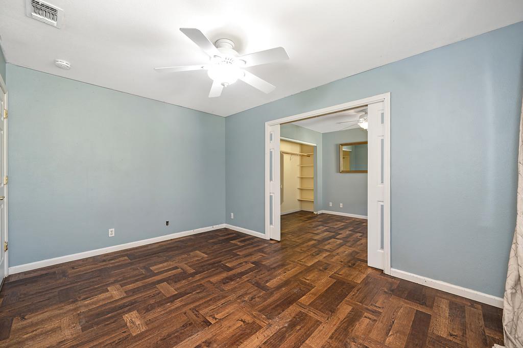 6181 Lambert Lane El Dorado, CA 95623 - Photo 37 of 68 unfurnished bedroom featuring dark wood-style floors and a ceiling fan