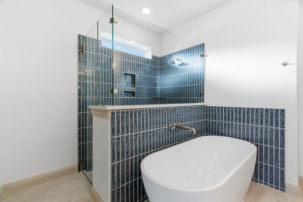 113 Rockford Street Rhome, TX 76078 - Photo 17 of 27 a bathroom with a bathtub and shower