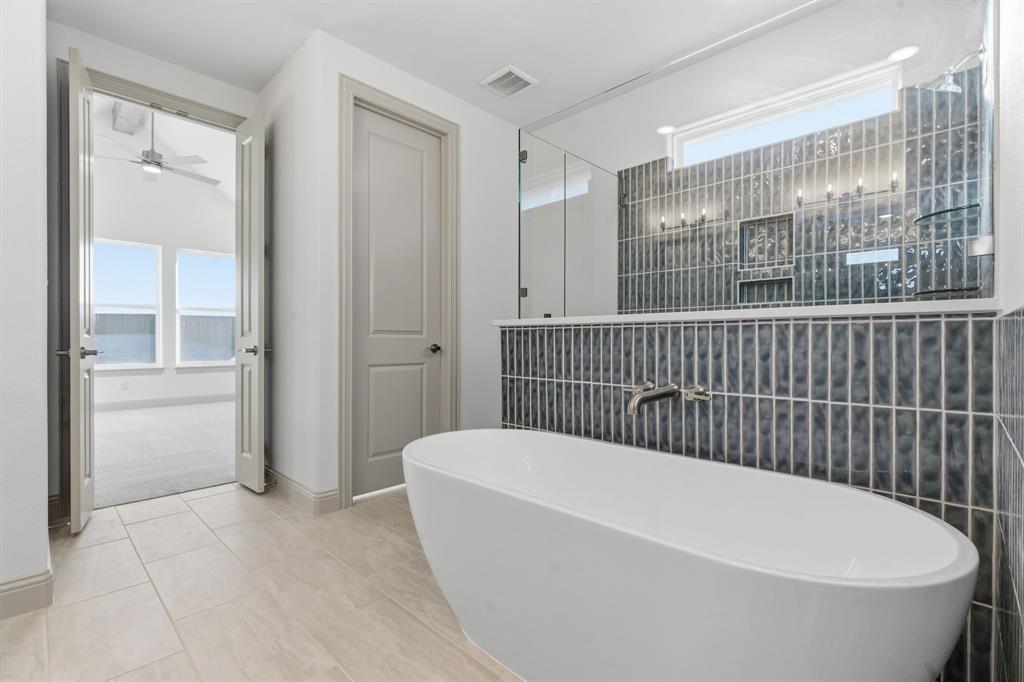 113 Rockford Street Rhome, TX 76078 - Photo 18 of 27 a bathroom with a bathtub and shower