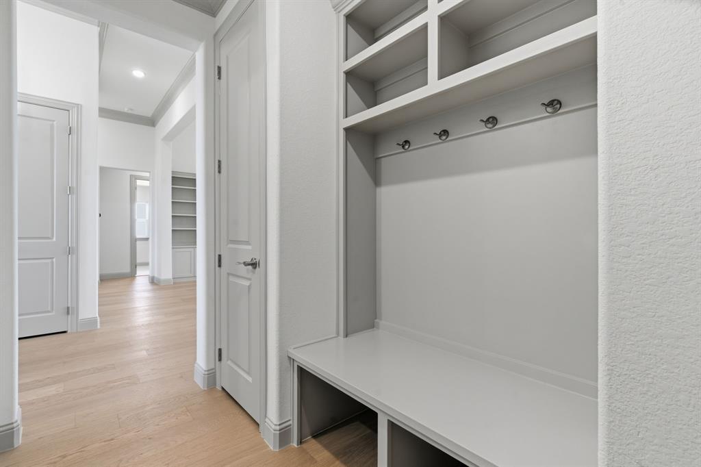 113 Rockford Street Rhome, TX 76078 - Photo 19 of 27 a view of a hallway with wooden floor and closet