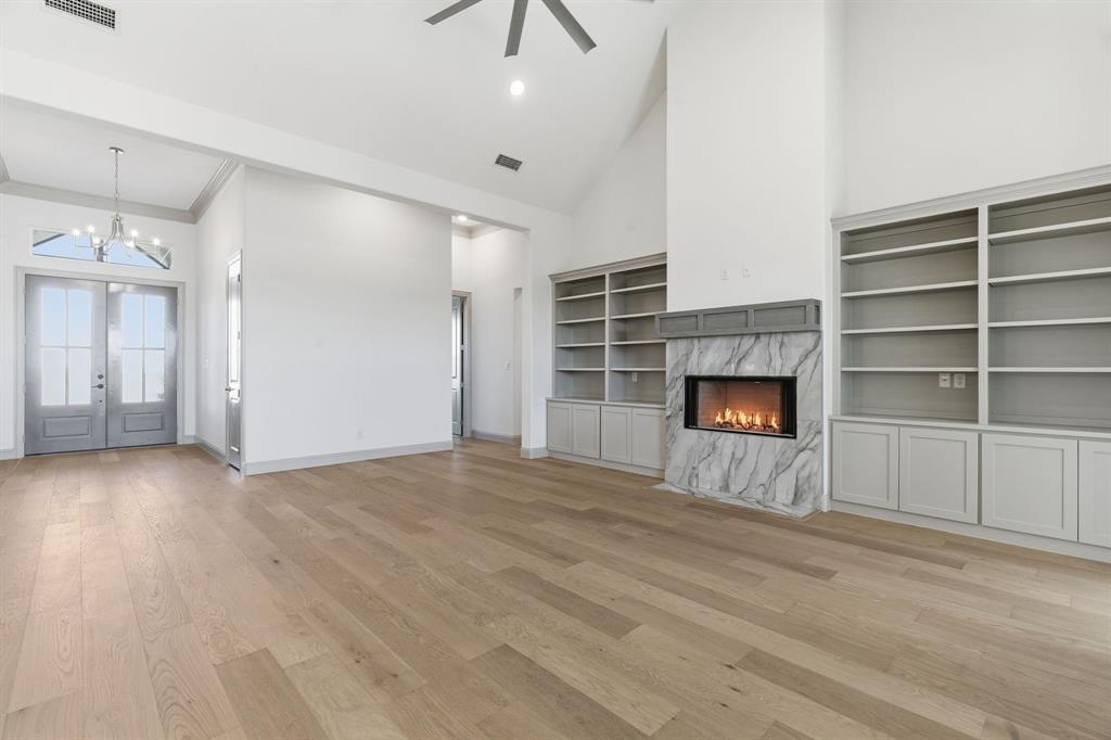 113 Rockford Street Rhome, TX 76078 - Photo 2 of 27 a view of an empty room with a fireplace and a window