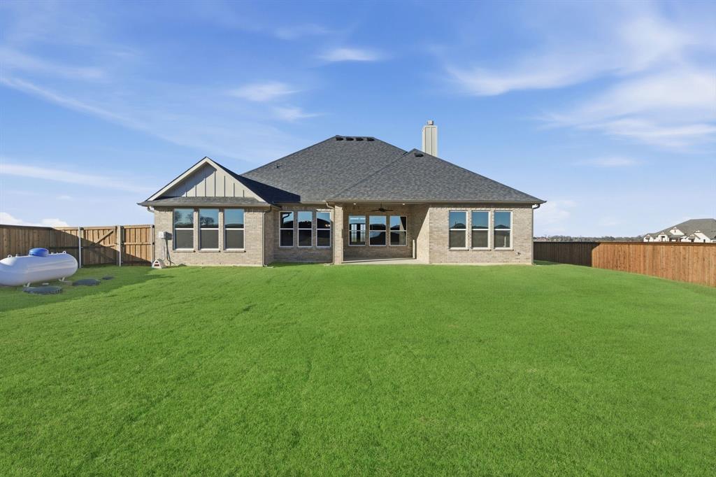 113 Rockford Street Rhome, TX 76078 - Photo 24 of 27 a front view of a house with a garden