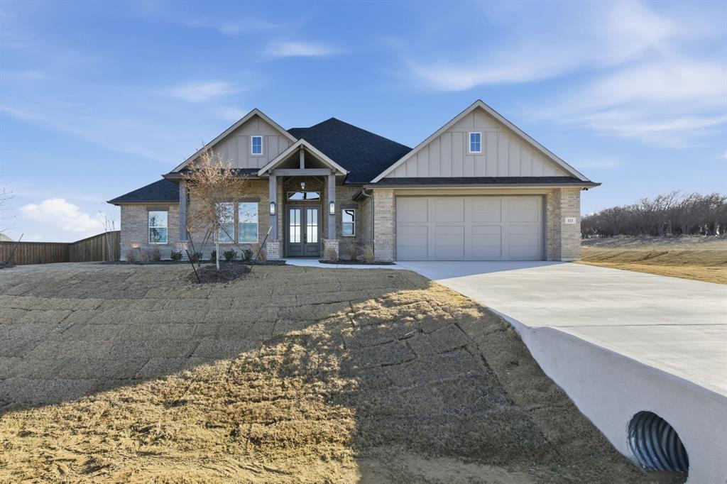 113 Rockford Street Rhome, TX 76078 - Photo 27 of 27 a front view of a house with a yard and garage