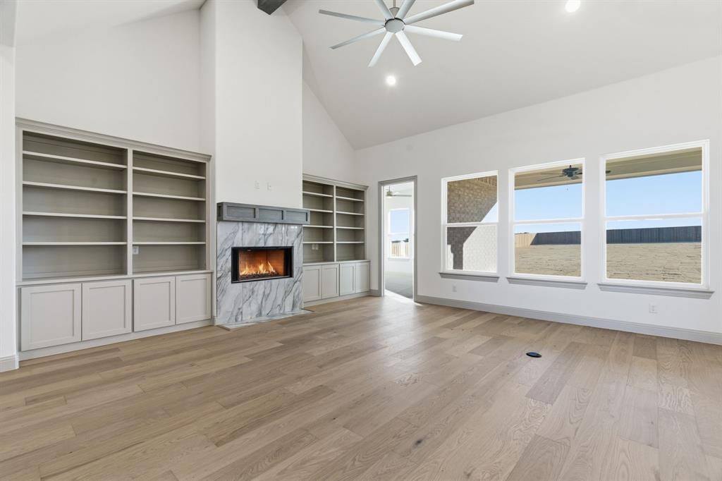 113 Rockford Street Rhome, TX 76078 - Photo 3 of 27 a view of an empty room with a window and wooden floor