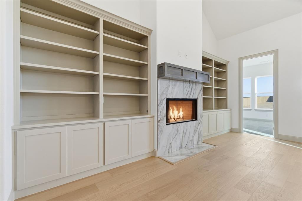 113 Rockford Street Rhome, TX 76078 - Photo 4 of 27 a view of an empty room with a fireplace and a window