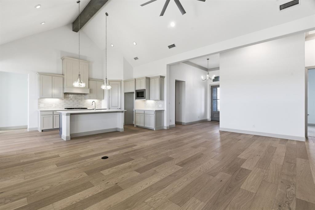 113 Rockford Street Rhome, TX 76078 - Photo 6 of 27 a view of a kitchen with a sink and a refrigerator