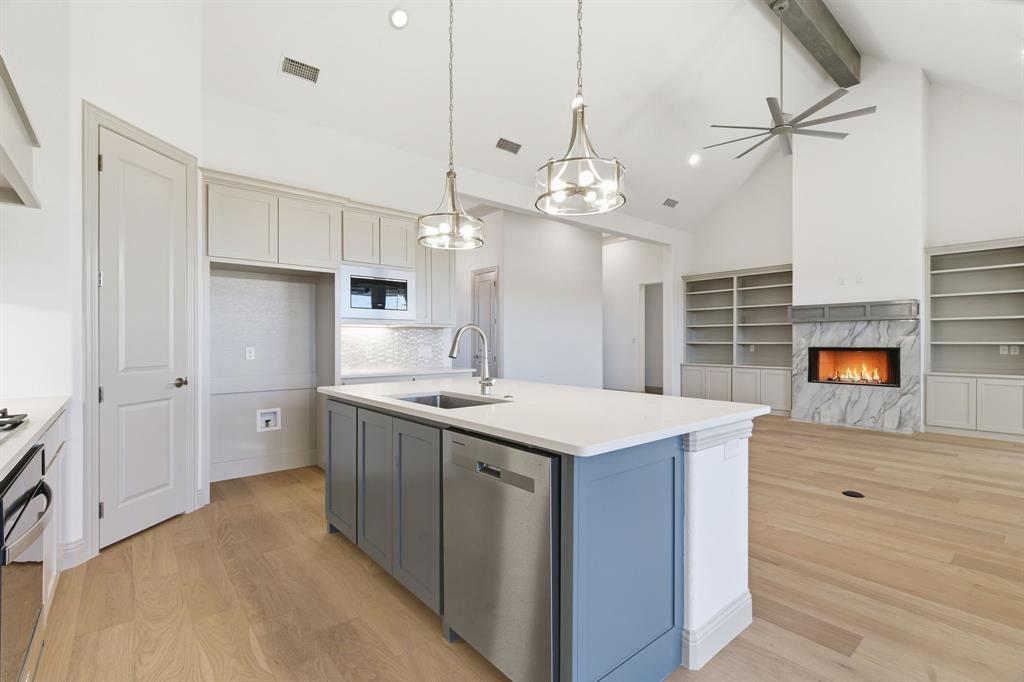 113 Rockford Street Rhome, TX 76078 - Photo 8 of 27 a kitchen with kitchen island a sink stove and refrigerator