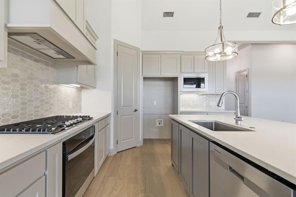 113 Rockford Street Rhome, TX 76078 - Photo 10 of 27 a kitchen that has a sink and a stove in it