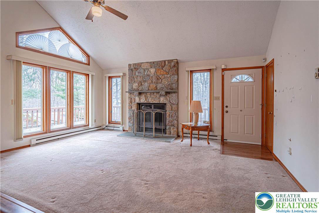 53 Panther Run Road Jim Thorpe, PA 18229 - Photo 13 of 53 an empty room with windows fireplace and fan