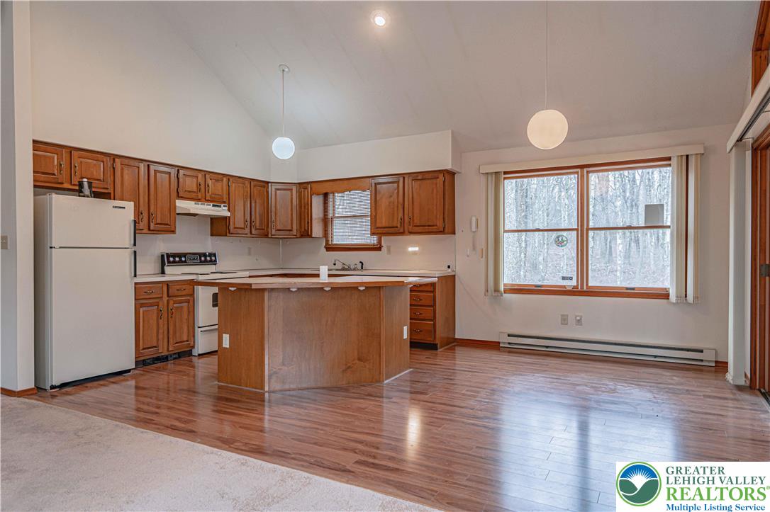 53 Panther Run Road Jim Thorpe, PA 18229 - Photo 16 of 53 a kitchen with stainless steel appliances granite countertop a refrigerator a sink dishwasher a stove with wooden cabinets and floors