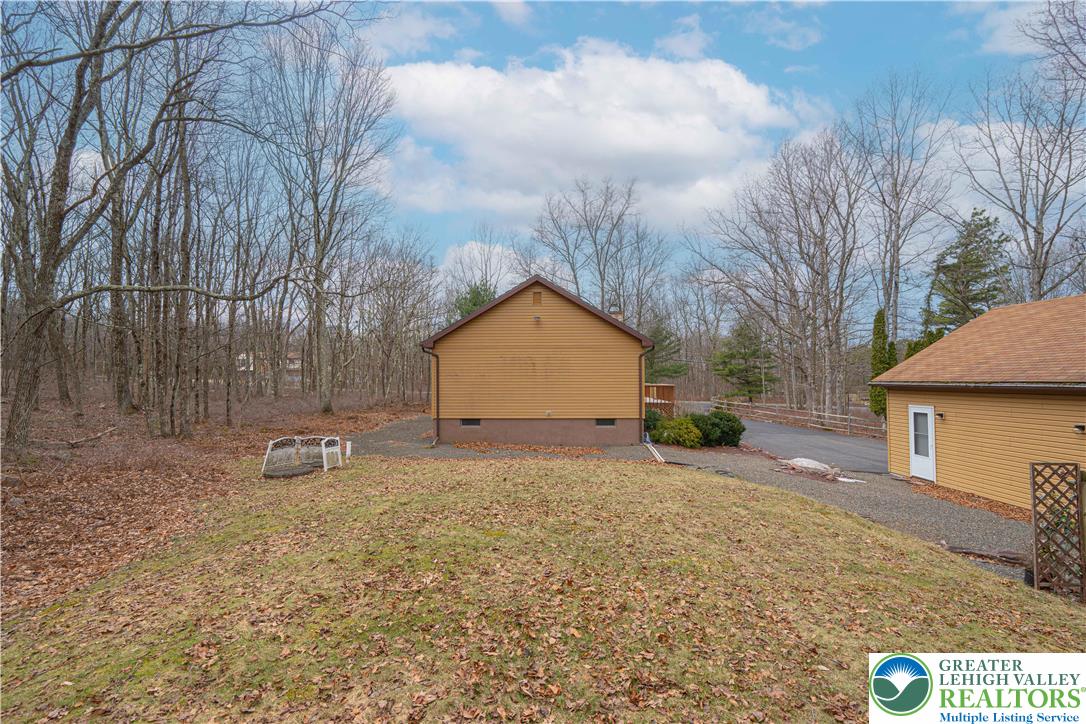 53 Panther Run Road Jim Thorpe, PA 18229 - Photo 47 of 53 a backyard of a house with large trees and outdoor seating