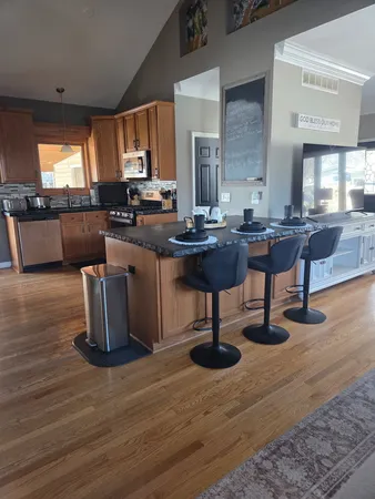 a living room with kitchen island furniture and a wooden floor