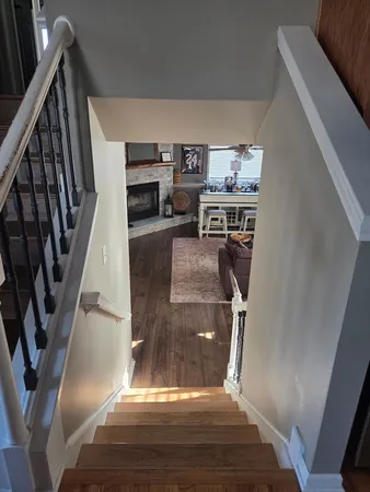 a living room with kitchen island furniture and a chandelier