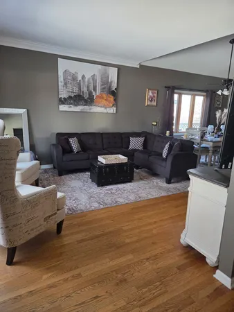a living room with furniture a rug and a flat screen tv