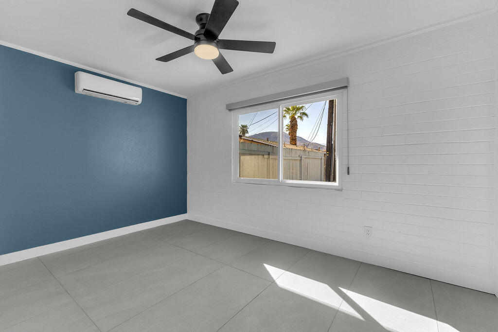 44635 San Carlos Avenue Palm Desert, CA 92260 - Photo 34 of 64 an empty room with ceiling fan and windows