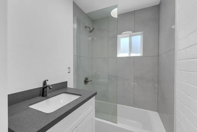 a kitchen with stainless steel appliances granite countertop a refrigerator and a stove