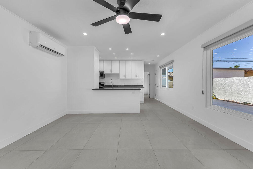 44635 San Carlos Avenue Palm Desert, CA 92260 - Photo 41 of 64 a view of kitchen with center island and stainless steel appliances wooden floor