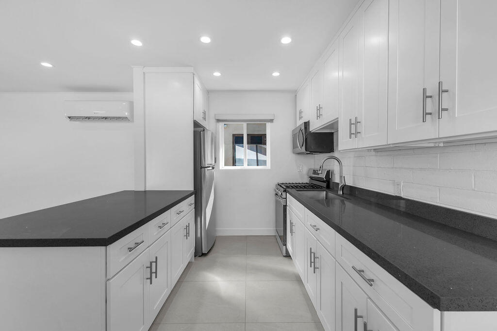 44635 San Carlos Avenue Palm Desert, CA 92260 - Photo 43 of 64 a kitchen with granite countertop a sink and cabinets