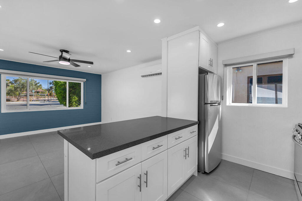 44635 San Carlos Avenue Palm Desert, CA 92260 - Photo 44 of 64 a kitchen with stainless steel appliances granite countertop a refrigerator and a stove
