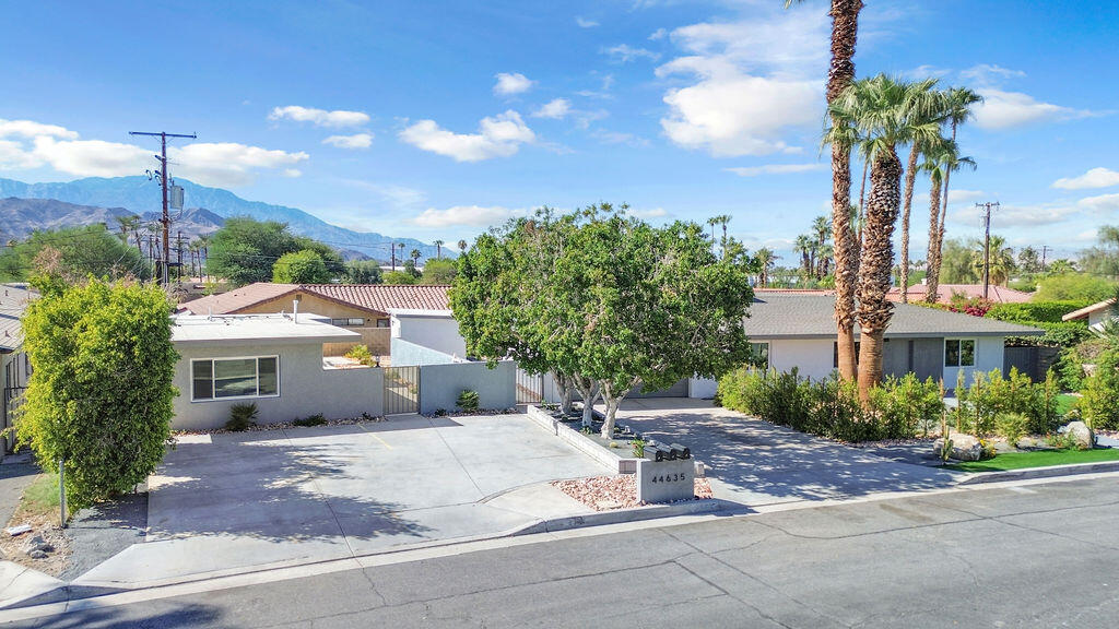 44635 San Carlos Avenue Palm Desert, CA 92260 - Photo 54 of 64 a front view of a house with a yard and potted plants