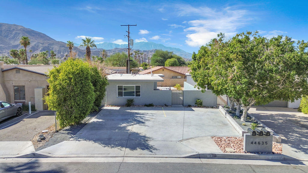 44635 San Carlos Avenue Palm Desert, CA 92260 - Photo 56 of 64 a view of a house with a yard and potted plants