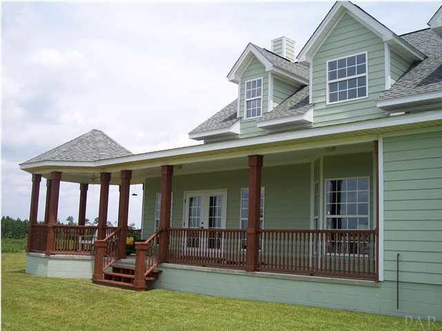 1747 Mineral Springs Road Jay, FL 32565 - Photo 23 of 24 French doors open to the family room, door to the right opens to laundry room. All windows are vinyl except the playroom. Siding is James Hardee plank...