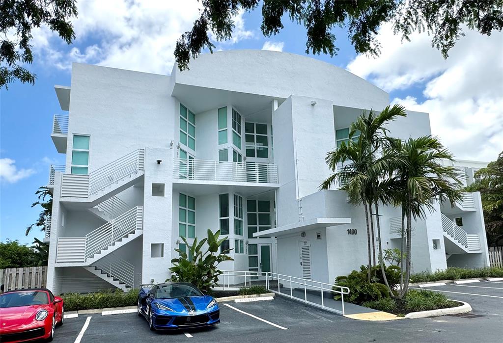1490 Southeast 15th Street, Unit 202 Fort Lauderdale, FL 33316 - Photo 25 of 31 a front view of a house with a yard and garage