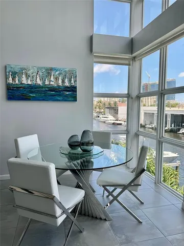 a view of a dining room with furniture and a potted plant