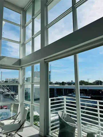 a view of a balcony with a chairs and iron stairs