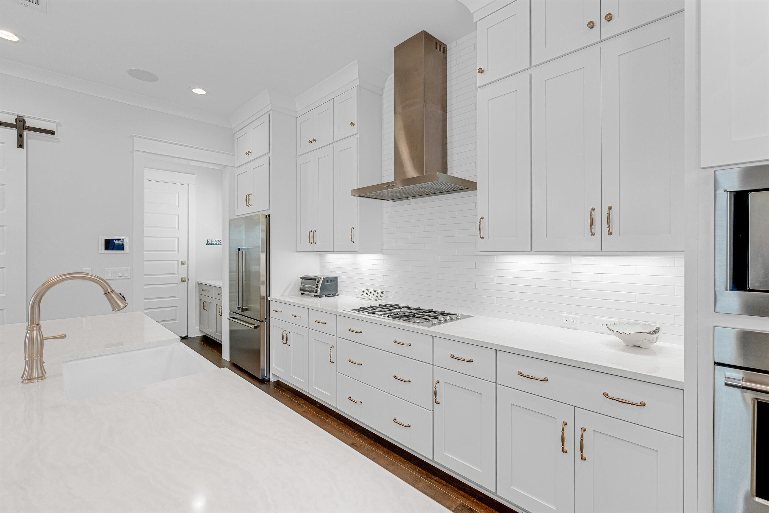 68 Ridgewalk Circle Santa Rosa Beach, FL 32459 - Photo 11 of 58 a kitchen with white cabinets stainless steel appliances and sink