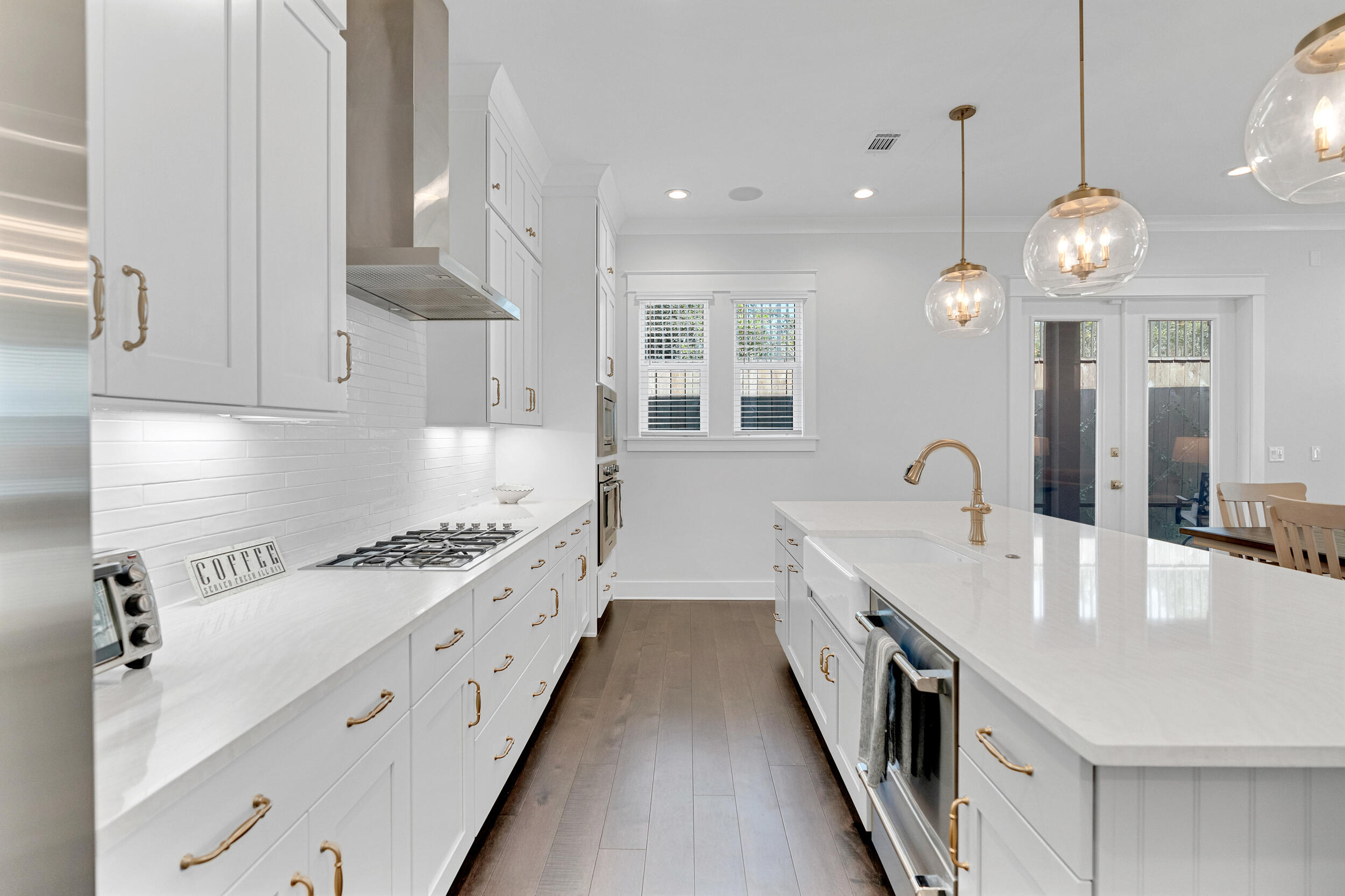 68 Ridgewalk Circle Santa Rosa Beach, FL 32459 - Photo 14 of 58 a large white kitchen with a large stove a sink dishwasher and a stove with wooden floor