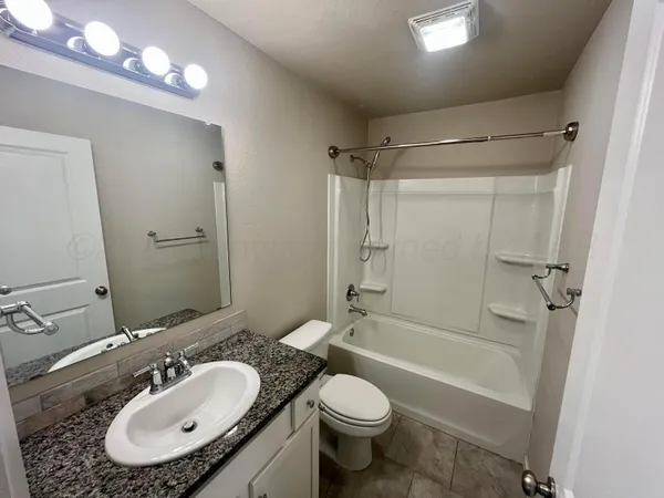 a bathroom with a sink toilet tub and shower