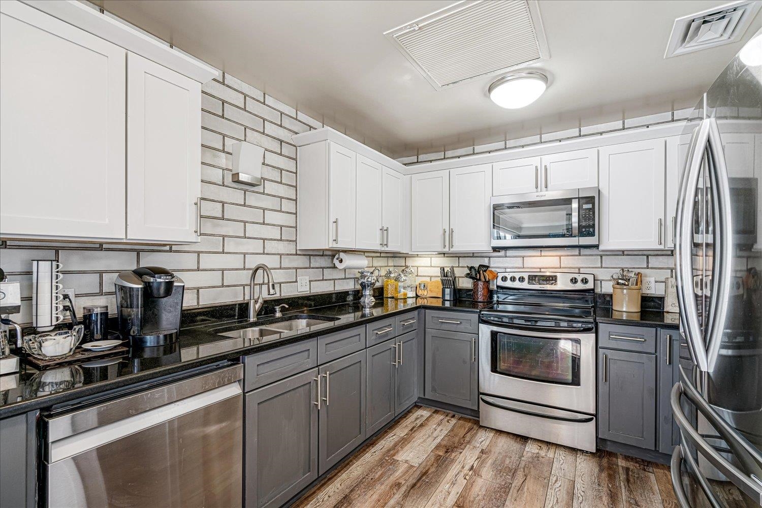 655 Riverside Drive, Unit 202 Memphis, TN 38103 - Photo 18 of 37 a kitchen with granite countertop a sink stainless steel appliances and cabinets