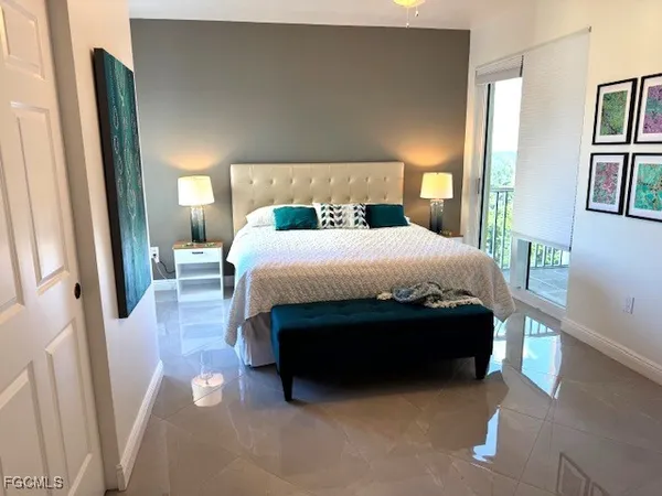 a bedroom with a bed and lamp