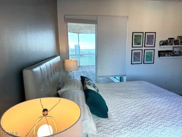 a living room with furniture and floor to ceiling window